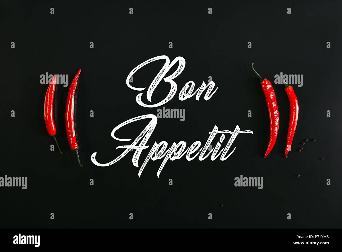 bon appetit inscription and red chili peppers on black Stock Photo