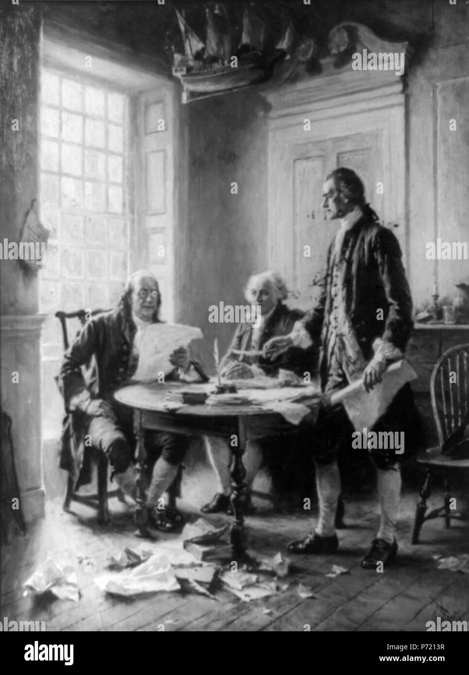 Benjamin Franklin reading draft of Declaration of Independence, John Adams seated, and Thomas Jefferson standing and holding feather pen and paper, around table. Reproduction of a painting by J.L.G. Ferris. Unknown date 147 Jefferson adams franklin Stock Photo