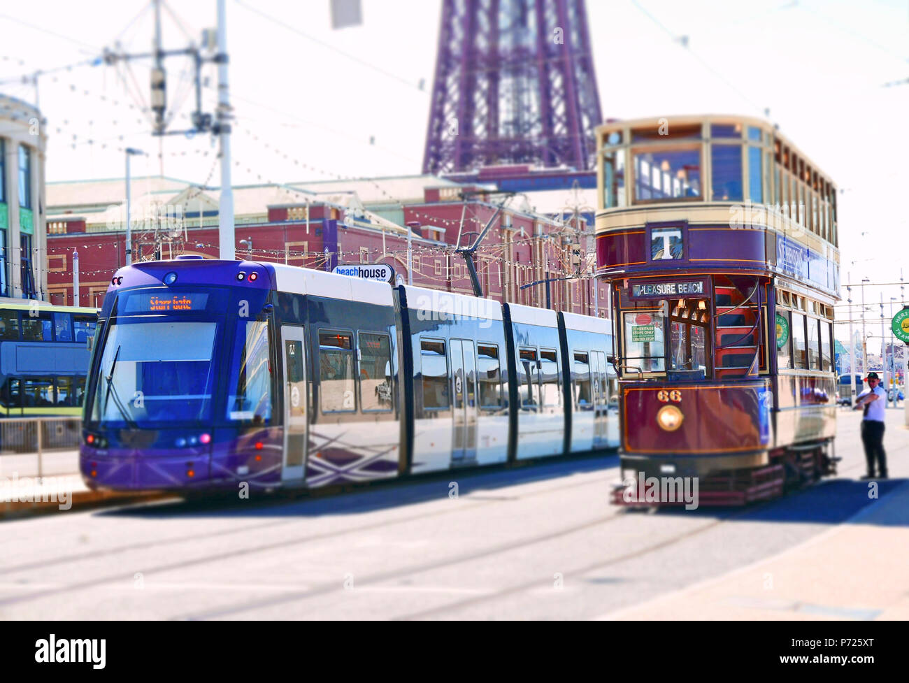 The old and the new. A contemporary Bombardier tram sits next to the  Blackpool Heritage tram tours 1901 Bolton Corporation tram 66 Stock Photo