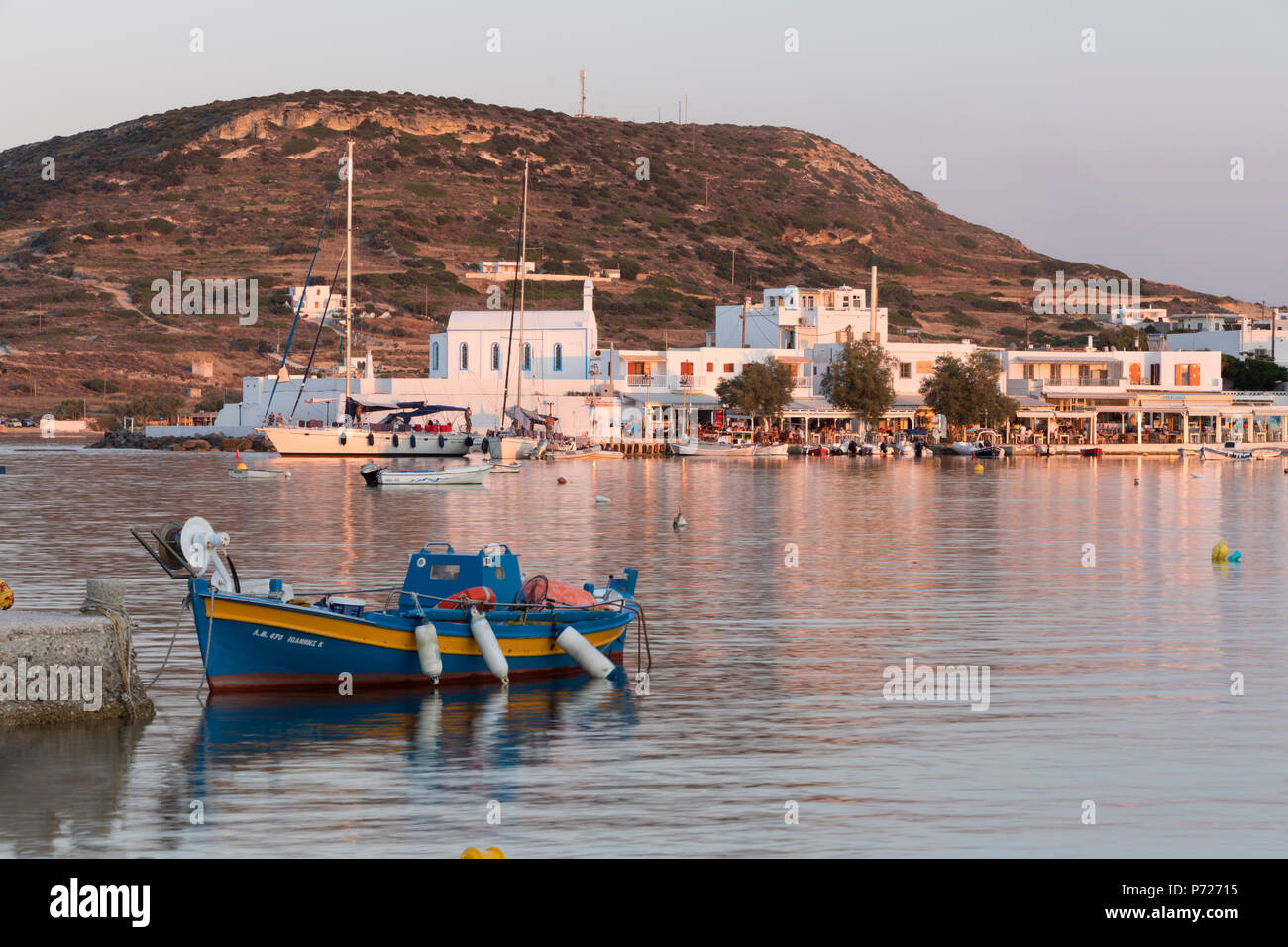 Fishing boat in harbour with town behind, Pollonia, Milos, Cyclades, Aegean Sea, Greek Islands, Greece, Europe Stock Photo