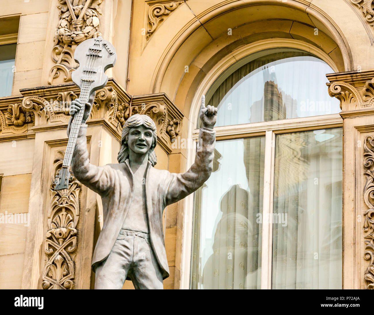 Statue of Paul McCartney holding a guitar outside Hard Day's Night Hotel, North John Street, Liverpool, England, UK Stock Photo
