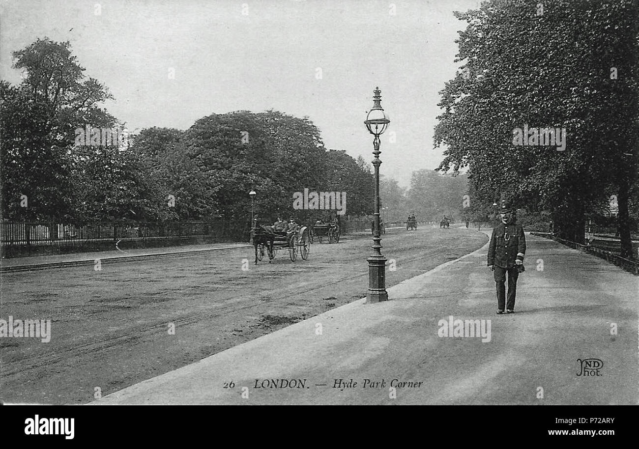 This looks like the 'Ring' in Hyde Park or at least the part which later became the northbound carriageway of Park Lane. The Police Constable is walking south towards Hyde Park Corner and Apsley House. Hard to date precisely but he is wearing the 1897 pattern tunic and the photograph is in the style of a Louis Levy postcard postcard which would mean that it is 1904 or 1905. Produced by the combined Levy and Neurdein company founded in 1919; the publishing style is Levy, and the 'ND Phot' logo indicates a Neurdein photo. 45 Hyde Park (18639531673) Stock Photo