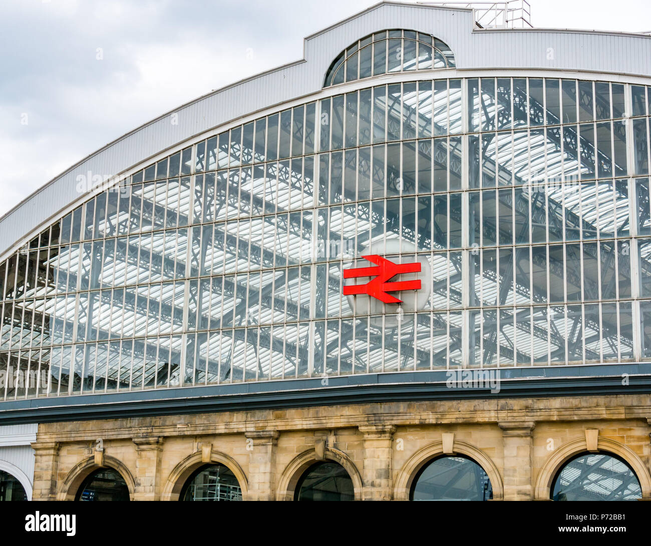 Curved glass roof of Liverpool Lime Street mainline railway station with Network Rail symbol, Liverpool, England, UK Stock Photo