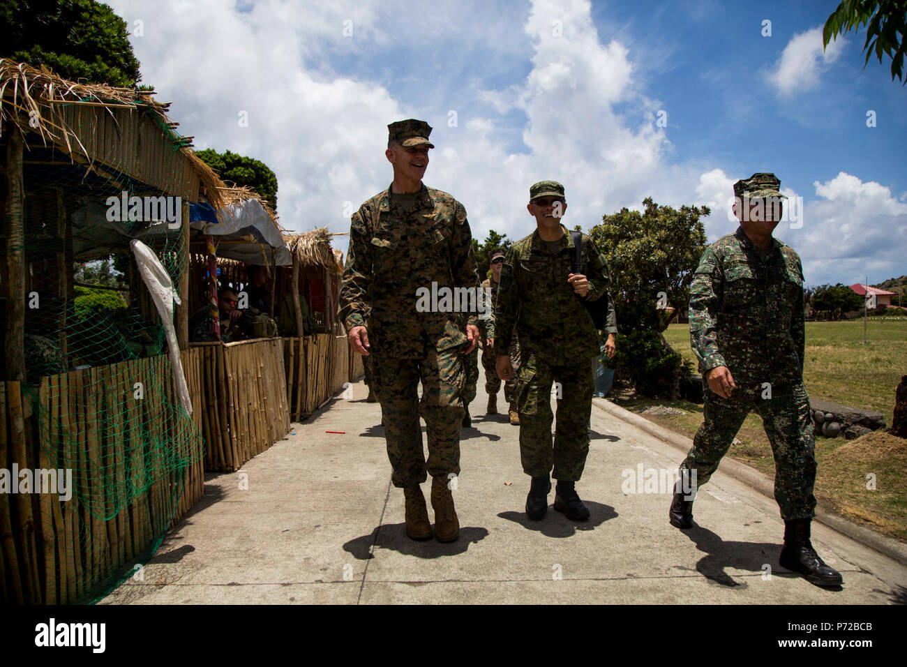 U.S. Marine Brig. Gen. John Jansen, commanding general, 3rd Marine Expeditionary Brigade, walks with Philippine Marine Corps Maj. Gen. Elvin Velasco and Philippine Air Force Brig. Gen. Restituto Padilla during a civil military assistance from the sea humanitarian assistance and disaster relief scenario in support of Balikatan 2017 in Batan, Batanes, May 11, 2017. Balikatan is an annual U.S.-Philippine bilateral military exercise focused on a variety of missions, including humanitarian assistance and disaster relief, counterterrorism, and other combined military operations. Stock Photo