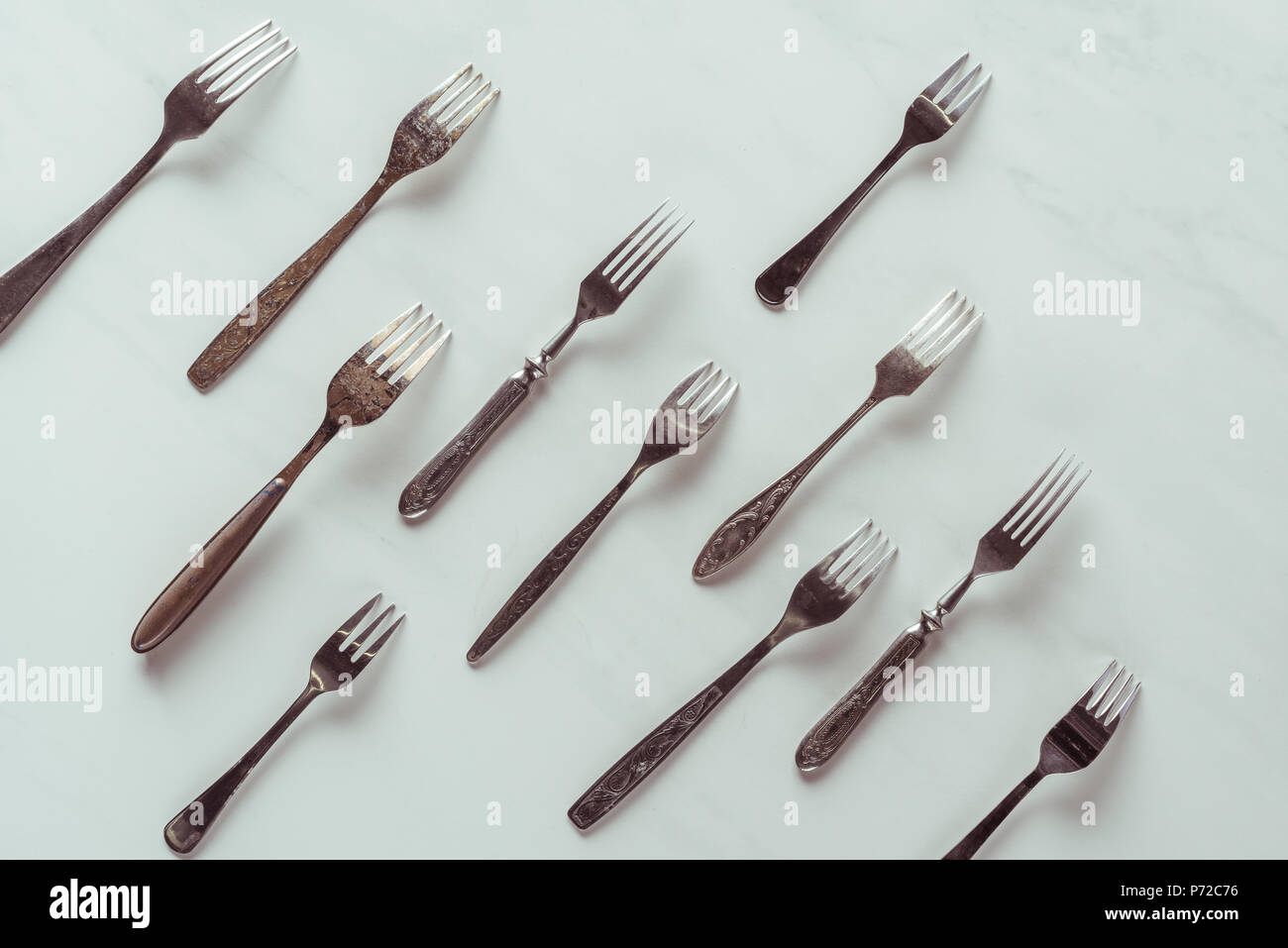Old metal forks in rows on white background Stock Photo Alamy