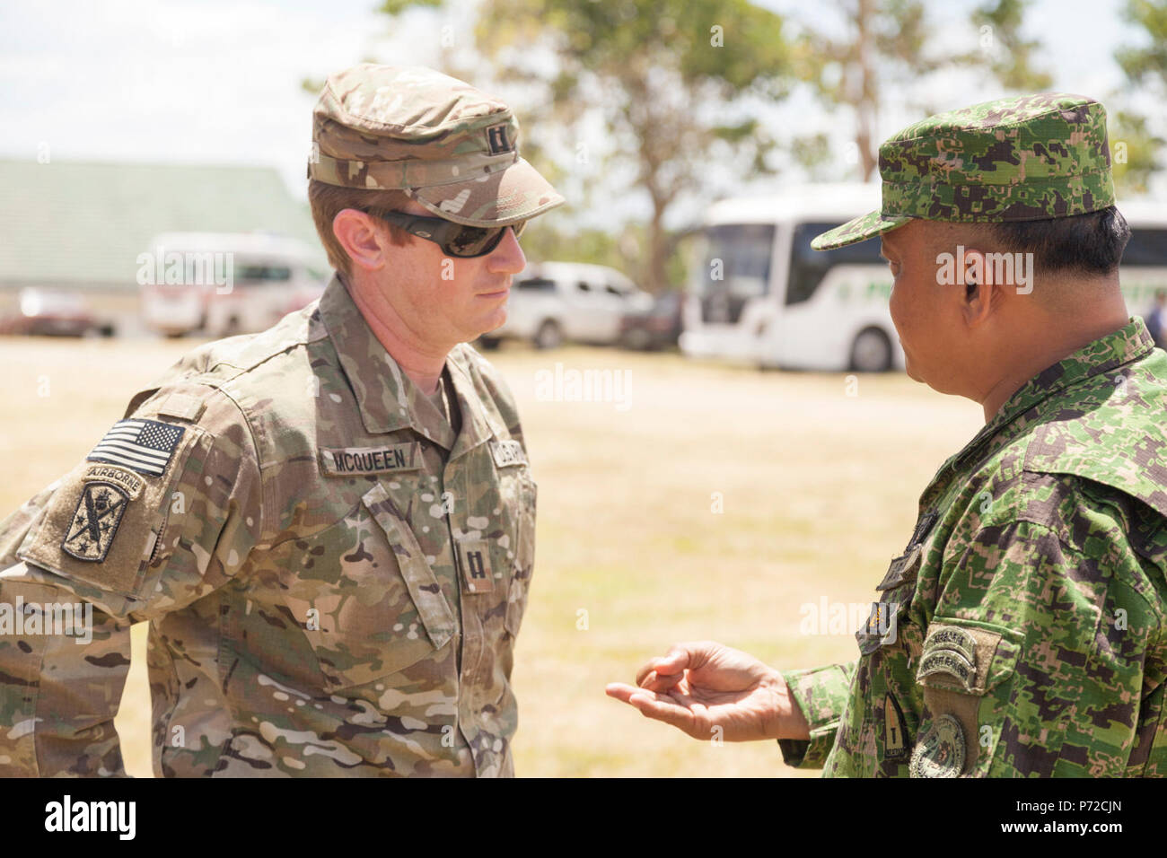 U.S. Army Capt. Robert McQueen speaks with Philippine Army Col. Lawrence Mina during a site visit in support of Balikatan 2017 at Camp Dela Cruz in Upi, Gamu, Isabela, May 11, 2017. McQueen is a civil affairs officer with the 405th Civil Affairs Battalion and Mina is the deputy assistant chief of staff for Training and Education Staff, Philippine Army. Balikatan is an annual U.S.-Philippine bilateral military exercise focused on a variety of missions, including humanitarian assistance and disaster relief, counterterrorism and other combined military operations. Stock Photo