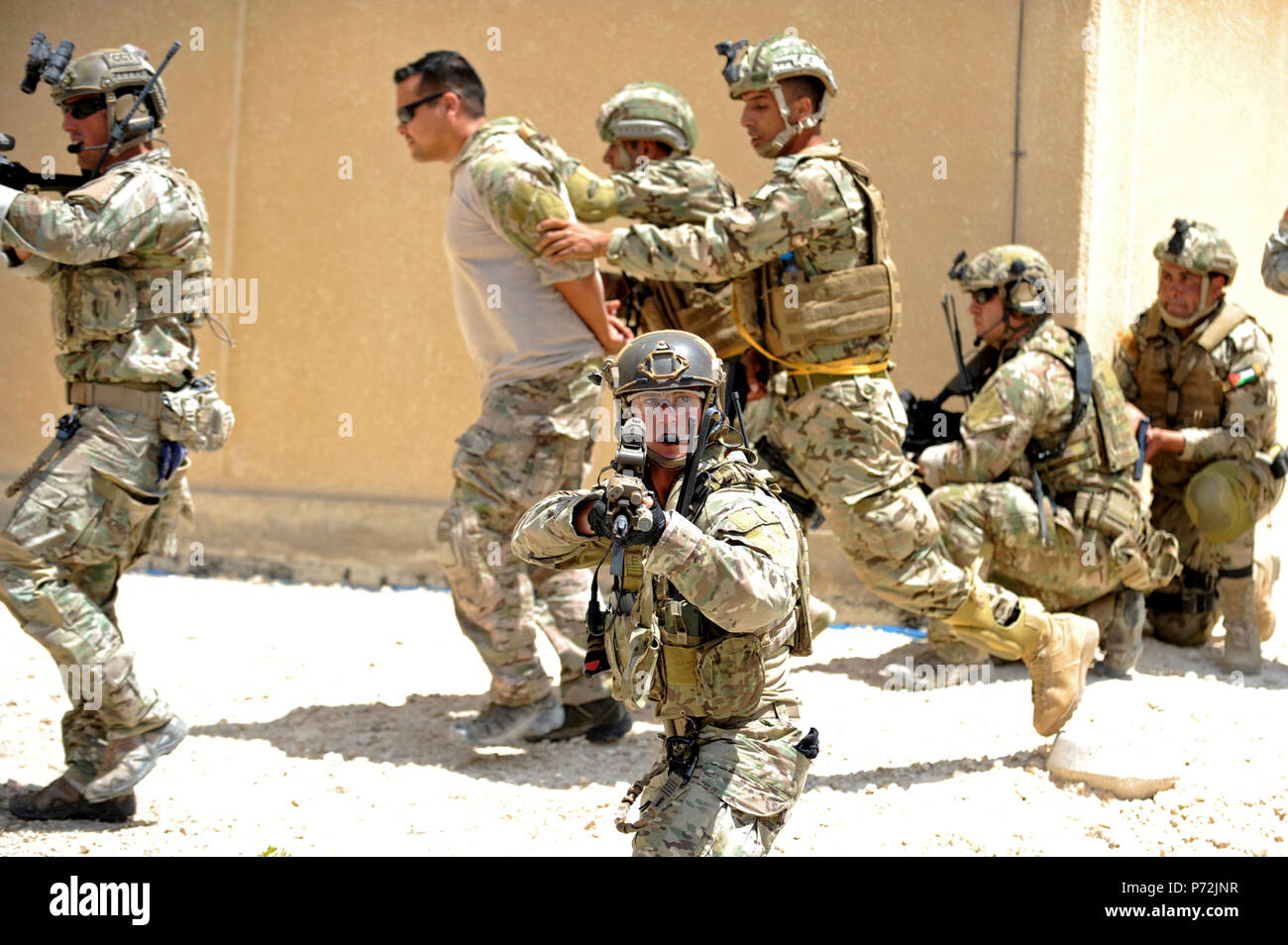 Jordan (May 11, 2017) Members of the Jordanian Armed Forces Special Task Force, and U.S. Air Force Special Operations, escort a prisoner, during an interoperability combat search and rescue training at the King Abdullah II Special Operations Training Center, as part of Exercise Eager Lion. Eager Lion is an annual U.S. Central Command exercise in Jordan designed to strengthen military-to-military relationships between the U.S., Jordan and other international partners. This year's iteration is comprised of about 7,200 military personnel from more than 20 nations that will respond to scenarios in Stock Photo