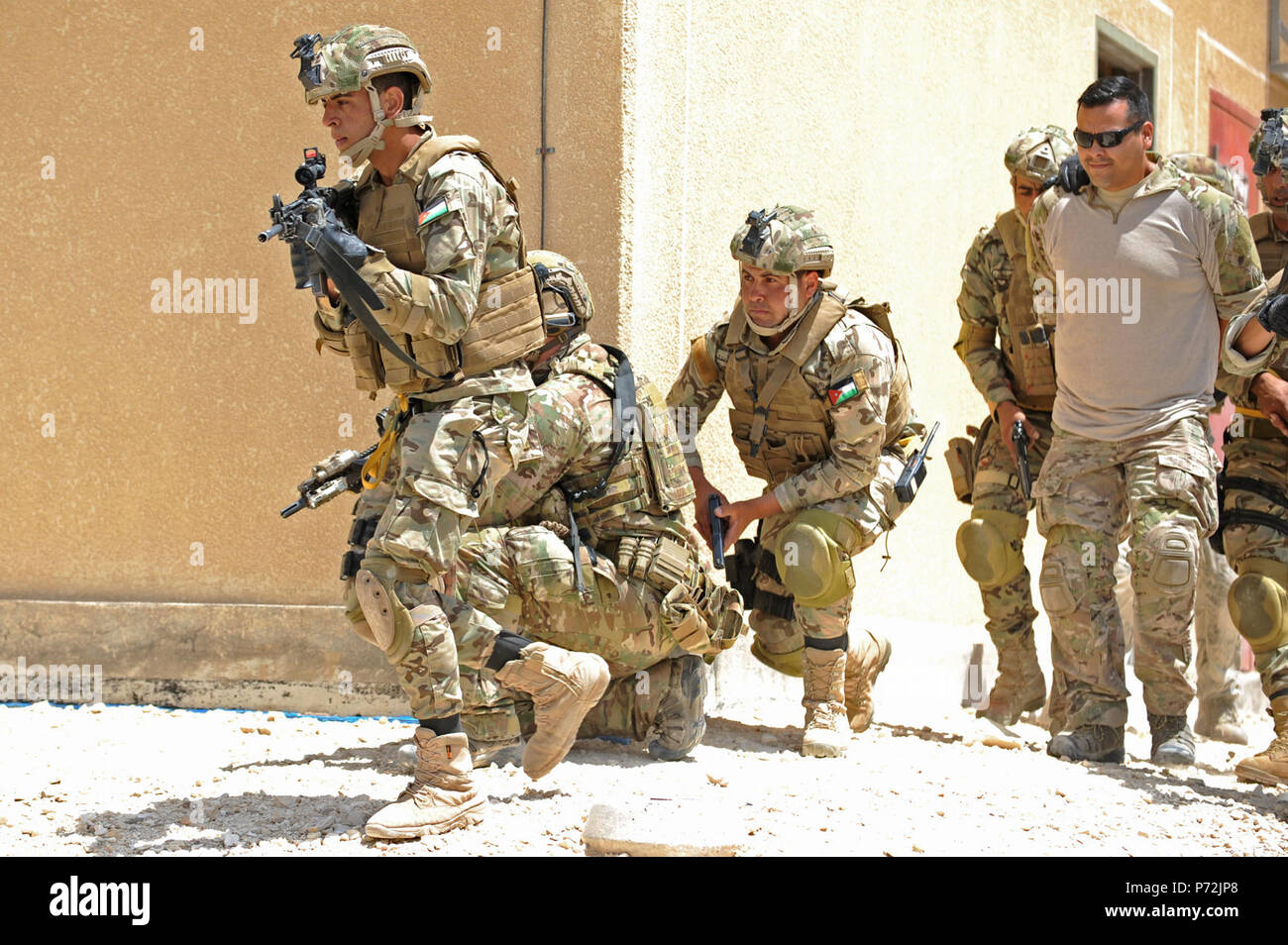 Jordan (May 11, 2017) Members of the Jordanian Armed Forces Special Task Force, and U.S. Air Force Special Operations, escort a prisoner, during an interoperability combat search and rescue training at the King Abdullah II Special Operations Training Center, as part of Exercise Eager Lion. Eager Lion is an annual U.S. Central Command exercise in Jordan designed to strengthen military-to-military relationships between the U.S., Jordan and other international partners. This year's iteration is comprised of about 7,200 military personnel from more than 20 nations that will respond to scenarios in Stock Photo