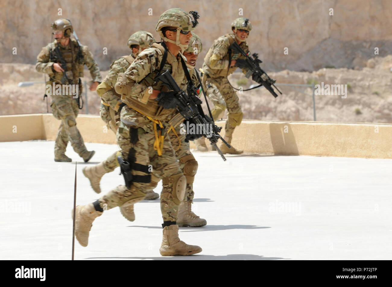 Jordan (May 11, 2017) Members of the Jordanian Armed Forces Special Task Force and U.S. Air Force Special Operations, fast rope drop on to a building, during an interoperability combat search and rescue training at the King Abdullah II Special Operations Training Center, as part of Exercise Eager Lion. Eager Lion is an annual U.S. Central Command exercise in Jordan designed to strengthen military-to-military relationships between the U.S., Jordan and other international partners. This year's iteration is comprised of about 7,200 military personnel from more than 20 nations that will respond to Stock Photo