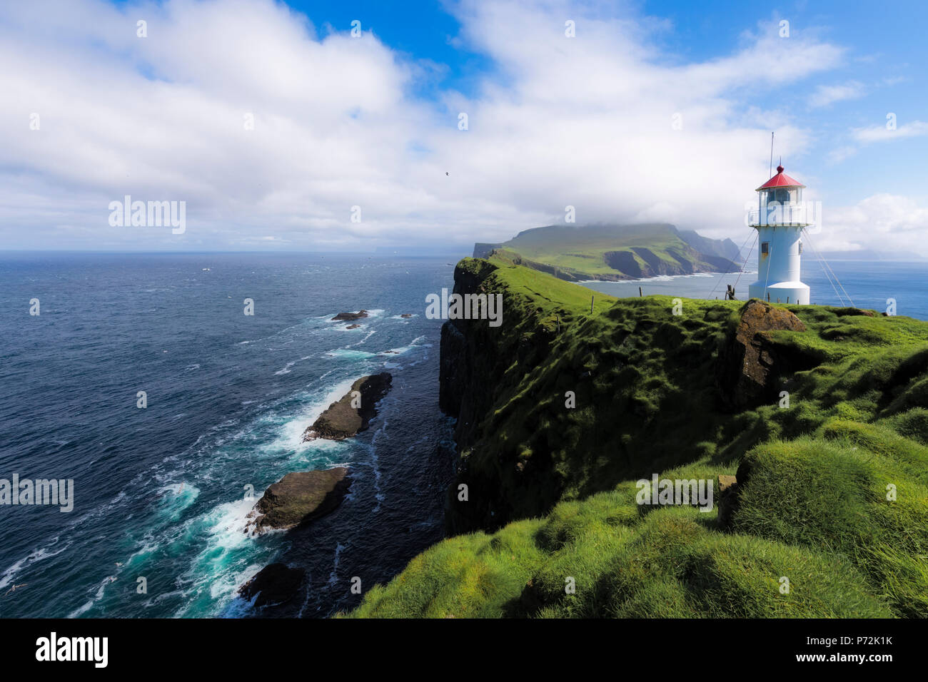 Lighthouse on islet known as Mykines Holmur, Mykines Island, Faroe Islands, Denmark, Europe Stock Photo