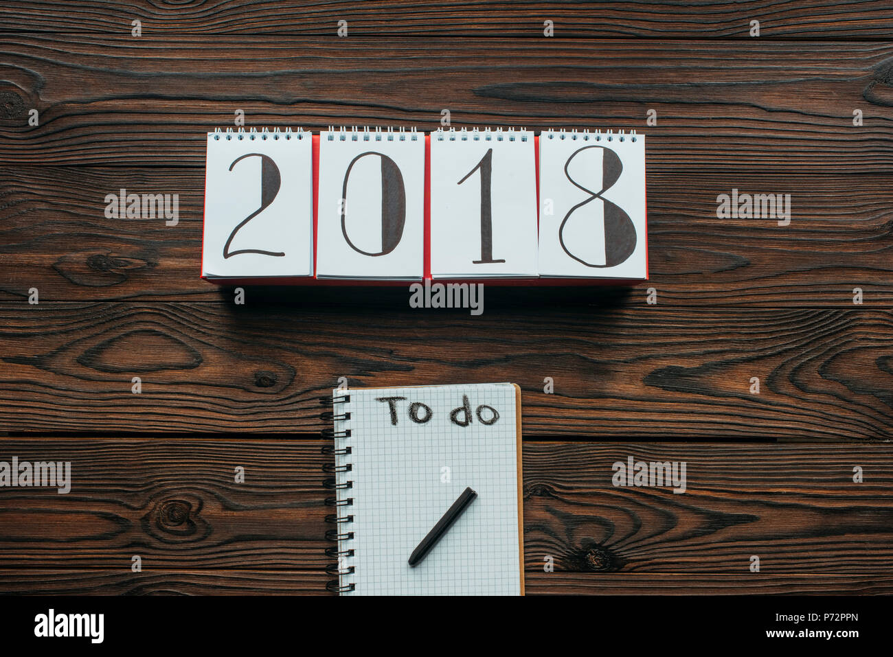 top view of 2018 calendar and notebook with to do lettering on wooden tabletop Stock Photo