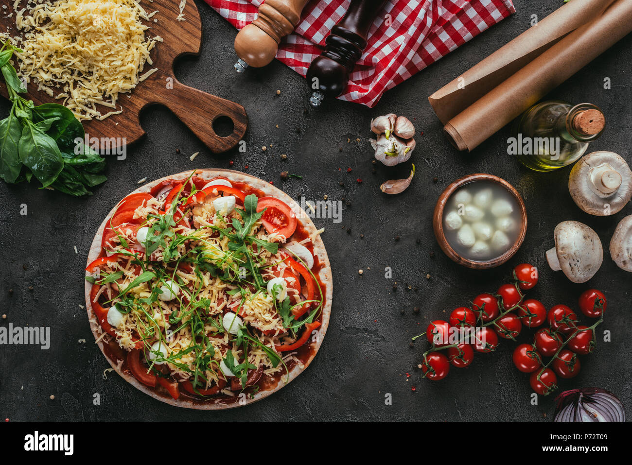 top view of unprepared pizza with ingredients on concrete table Stock Photo