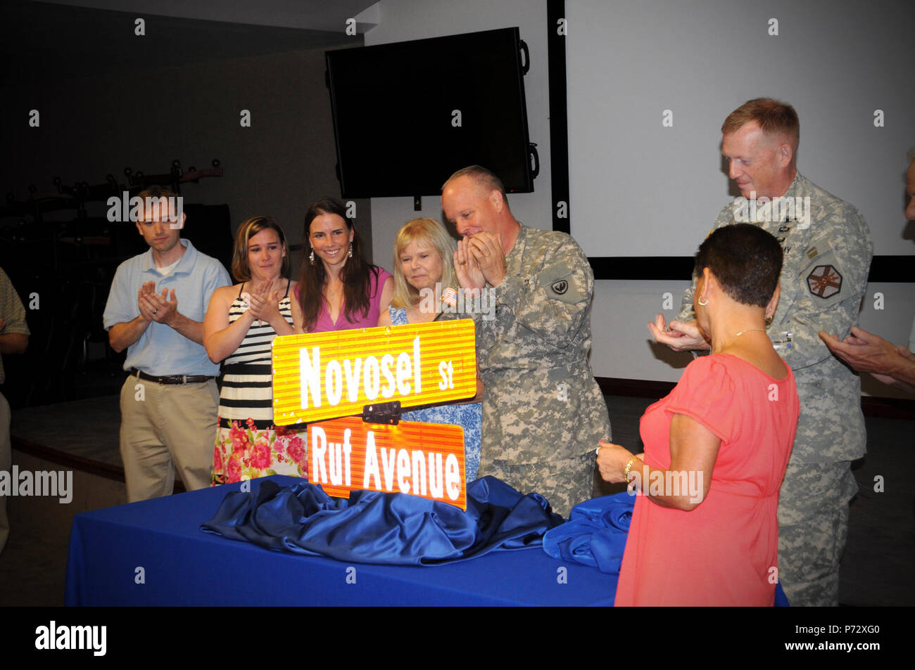 Maj. Gen. Kevin W. Mangum (center), commanding general of the U.S. Army Aviation Center of Excellence, and Family members of CW4 William “Willie” L. Ruf unveil a street sign dedicated in Ruf’s honor at Fort Rucker headquarters.  Fort Rucker’s 5th Avenue was renamed Ruf Avenue June 18, 2013. Stock Photo