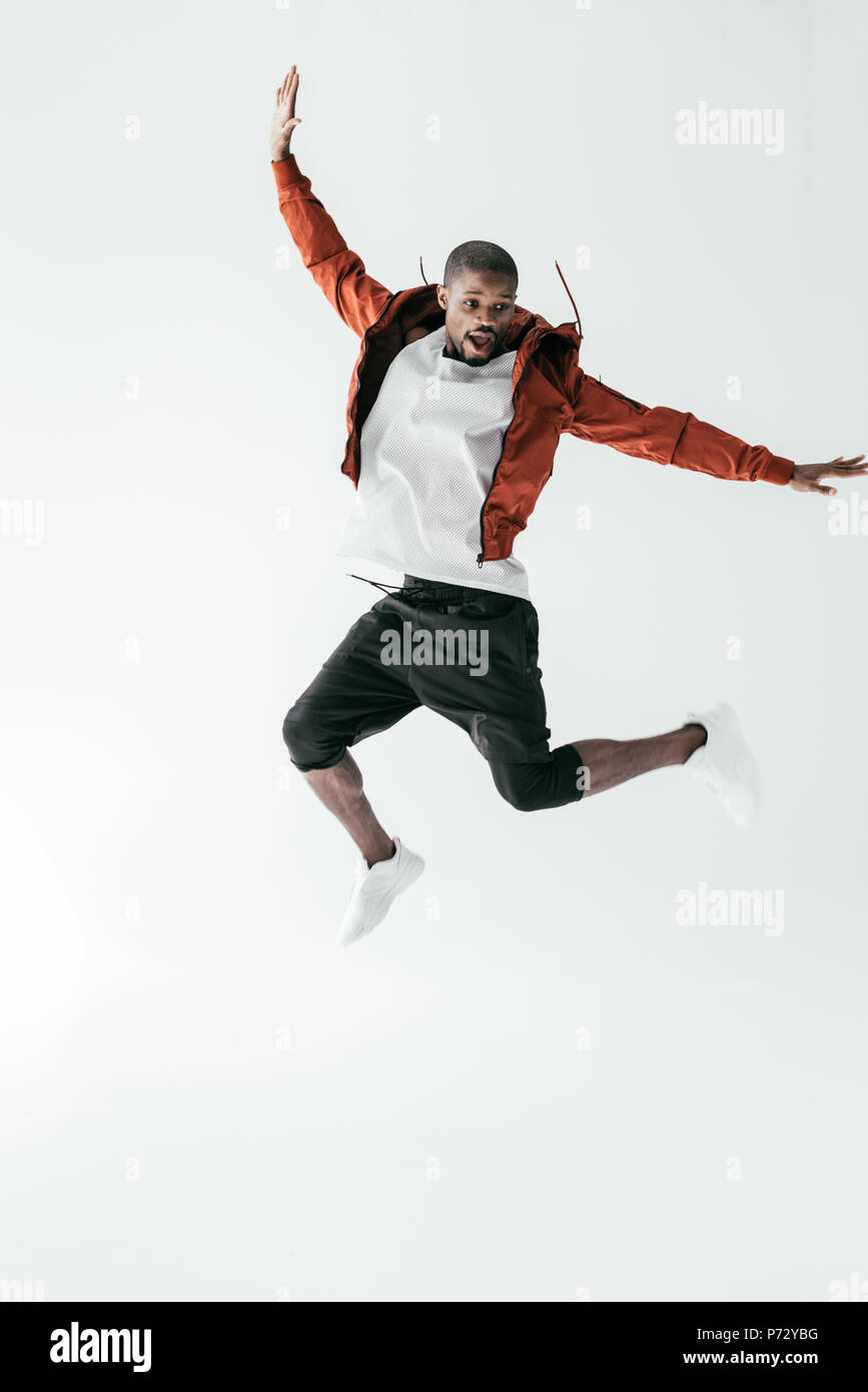 excited african american man jumping in sportswear, isolated on white Stock Photo