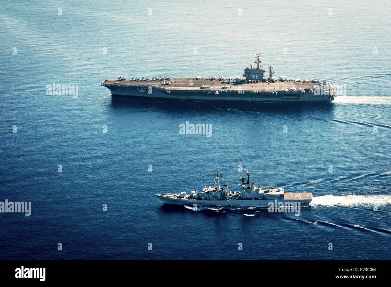 SEA (Oct. 26, 2013) The aircraft carrier USS Nimitz (CVN 68) and the Italian destroyer Francesco Mimbelli (D561) are underway during operations in the central Mediterranean Sea. Nimitz is deployed supporting maritime security operations and theater security cooperation efforts in the U.S. 6th Fleet area of operations. Stock Photo