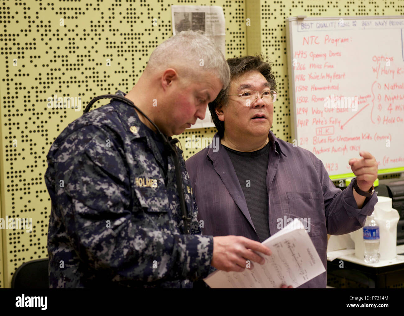 WASHINGTON (March 20, 2014) Trumpet artist Harry Kim, rehearsing with the U.S. Navy Band Commodores jazz ensemble, discusses music with Chief Musician Rob Holmes, of McLean, Va. Kim will join the Commodores for a special concert the National Trumpet Competition in Mechanicsburg, Pa. March 21. Stock Photo