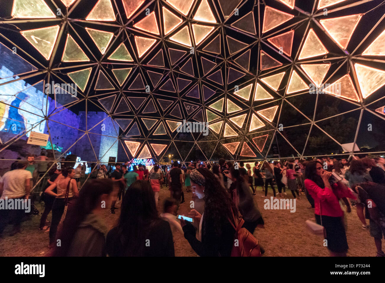 Jerusalem, Israel. 3rd Jul, 2018. People inside a glowing geodesic dome near the walls of the Old city of Jerusalem during the 2018 Festival of lights. This is the 10th anniversary of the festival, festival, israel, jerusalem, Jerusalem. The Festival of Lights in the Old city, which draws hundreds of thousands of visitors to the old city of Jerusalem, which is lit by many light sculptures and shows Credit: Yagil Henkin/Alamy Live News Stock Photo