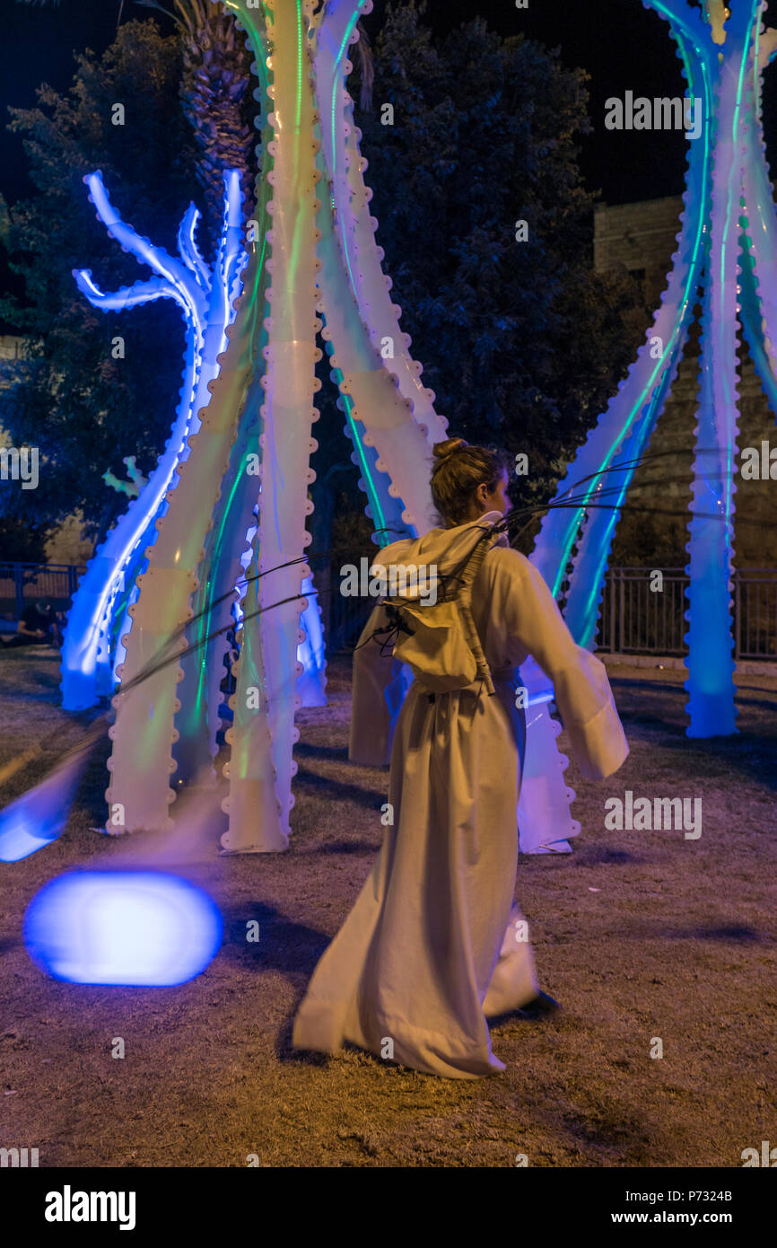 Jerusalem, Israel. 3rd Jul, 2018. A dancer in front of a light sculpture near the walls of the Old city of Jerusalem during the 2018 Festival of lights. This is the 10th anniversary of the festival, festival, israel, jerusalem, Jerusalem. The Festival of Lights in the Old city, jewish, which draws hundreds of thousands of visitors to the old city of Jerusalem, which is lit by many light sculptures and shows Credit: Yagil Henkin/Alamy Live News Stock Photo