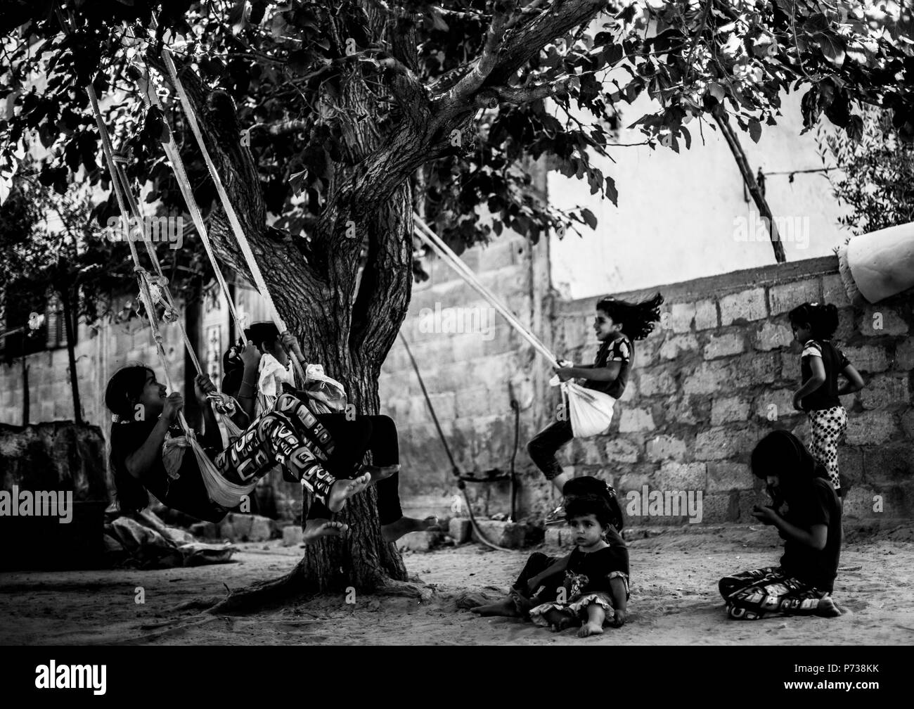 Gaza City, The Gaza Strip, Palestine. 3rd July, 2018. Palestinian refugee children play in a poverty-stricken quarter of the town of Beit Lahia, in the northern Gaza Strip. Credit: Mahmoud Issa/Quds Net News/ZUMA Wire/Alamy Live News Stock Photo