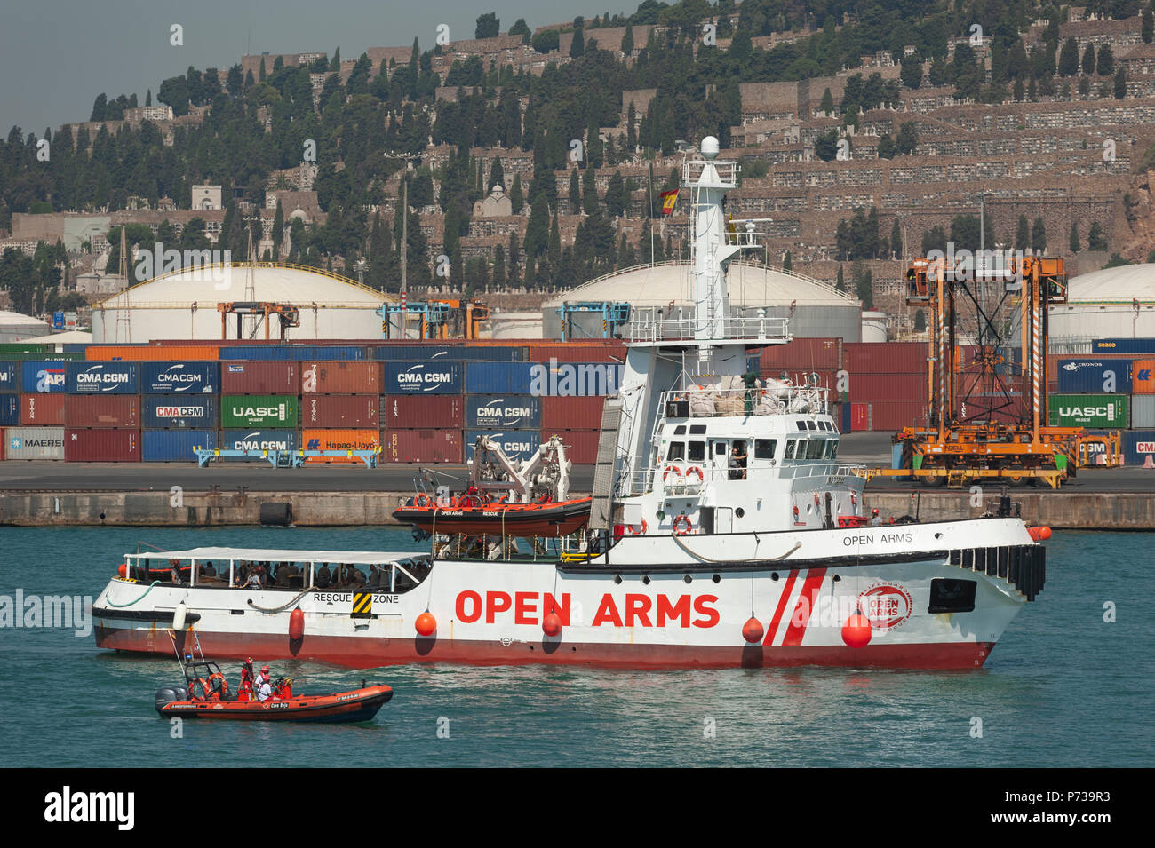Barcelona. 04th July, 2018.  The Open Arms ship, from the Spanish ONG Proactiva Open Arms, approaches for docking in the port of Barcelona. The humanitarian aid ship sailed to Spain with 60 immigrants from 14 different nationalities rescued on Saturday in waters near Libya, after it was rejected by Italy and Malta. Stock Photo