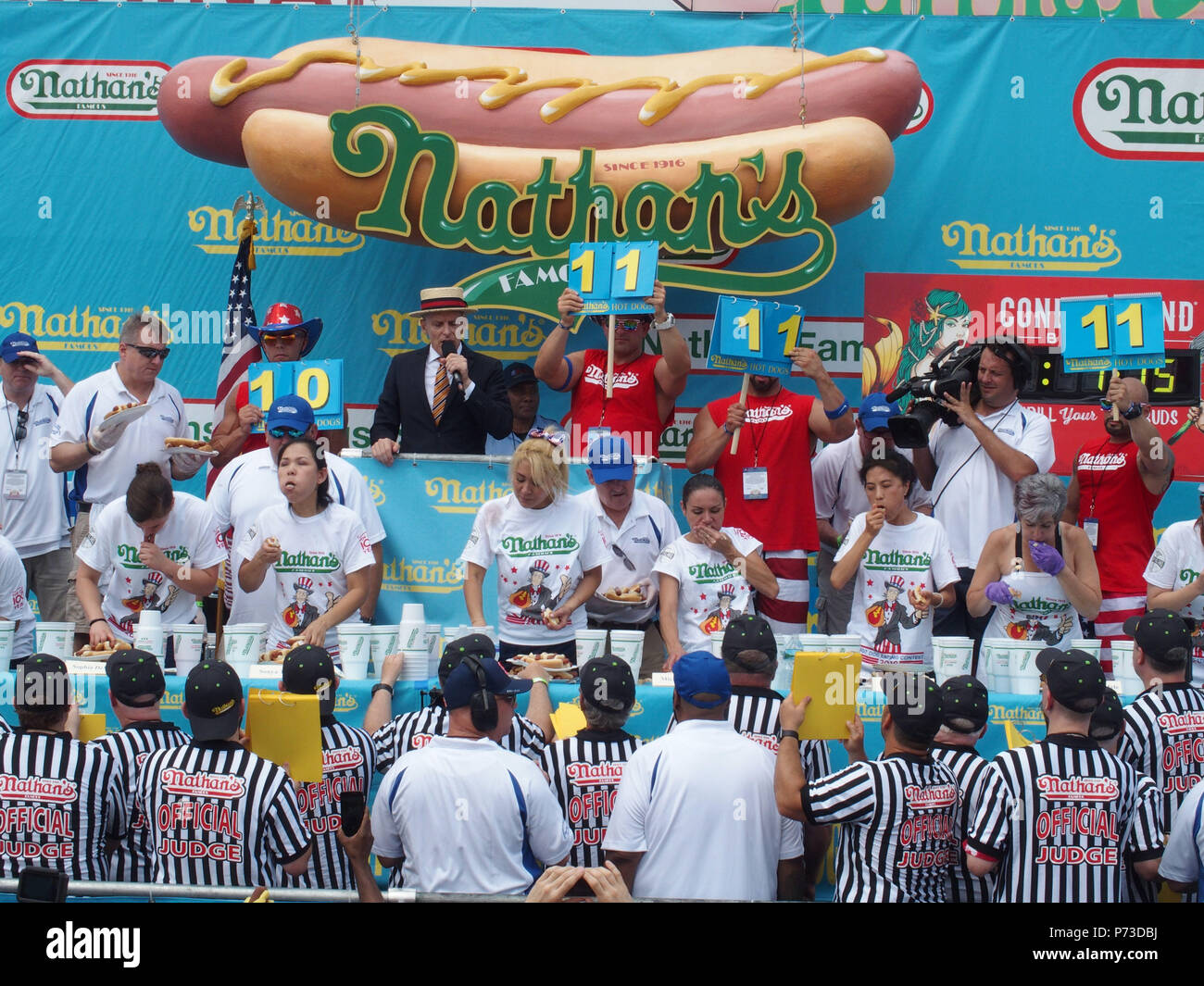July 4, 2018 - New York, New York, U.S. - The Nathanâ€™s hot dog eating contest is held on the Fourth of July at the original Nathanâ€™s Hot Dog location at the corner of Surf and Stillwell avenues in Coney Island and has become one of New Yorkâ€™s annual July 4th traditions. According to Nathanâ€™s, the competition dates back to as early as 1916, but the first recorded hot dog eating contest happened in 1972..More than 40,000 people will make their way to Coney Island to watch the contest and approximately 2 million people watch it live on TV or online. (Credit Image: © Bruce Cotler/Globe Pho Stock Photo