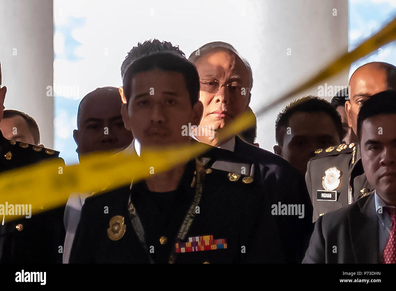 Kuala Lumpur, Malaysia. 4th July 2018. Najib Razak the former Malaysian Prime Minister is being escorted by police and MACC commissioner at Kuala Lumpur Court. Najib Razak the former Malaysian Prime Minister was arrested by Malaysian Anti-Corruption Commission (MACC) and charged at Kuala Lumphur Court. Credit: SOPA Images Limited/Alamy Live News Stock Photo