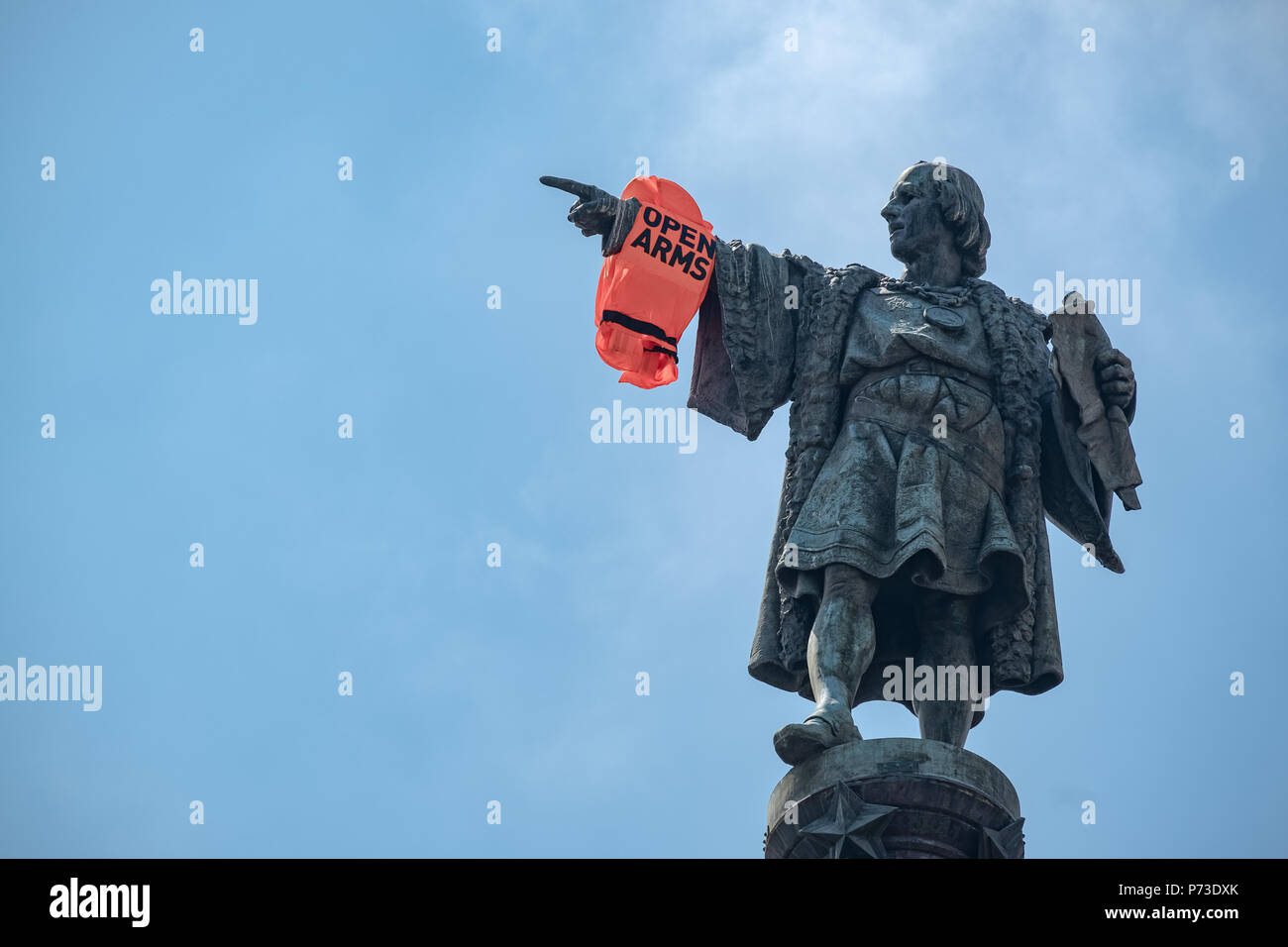 As A Result Of The Arrival In Barcelona Of The Opem Arms Members Of The Organization Have Hung A Life Jacket On The Arm Of The Conquistador At The Christopher Columbus Monument