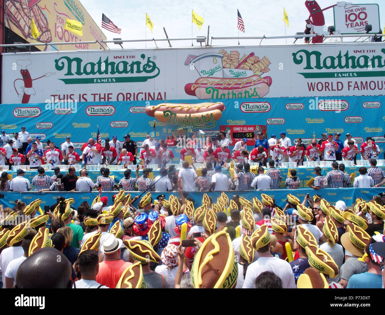 New York, New York, USA. 4th July, 2018. The Nathan's hot dog eating contest is held on the Fourth of July at the original Nathan's Hot Dog location at the corner of Surf and Stillwell avenues in Coney Island and has become one of New York's annual July 4th traditions. According to Nathan's, the competition dates back to as early as 1916, but the first recorded hot dog eating contest happened in 1972.More than 40,000 people will make their way to Coney Island to watch the contest and approximately 2 million people watch it live on TV or online. Miki Sudo Woman's winner and Joey Ches Stock Photo