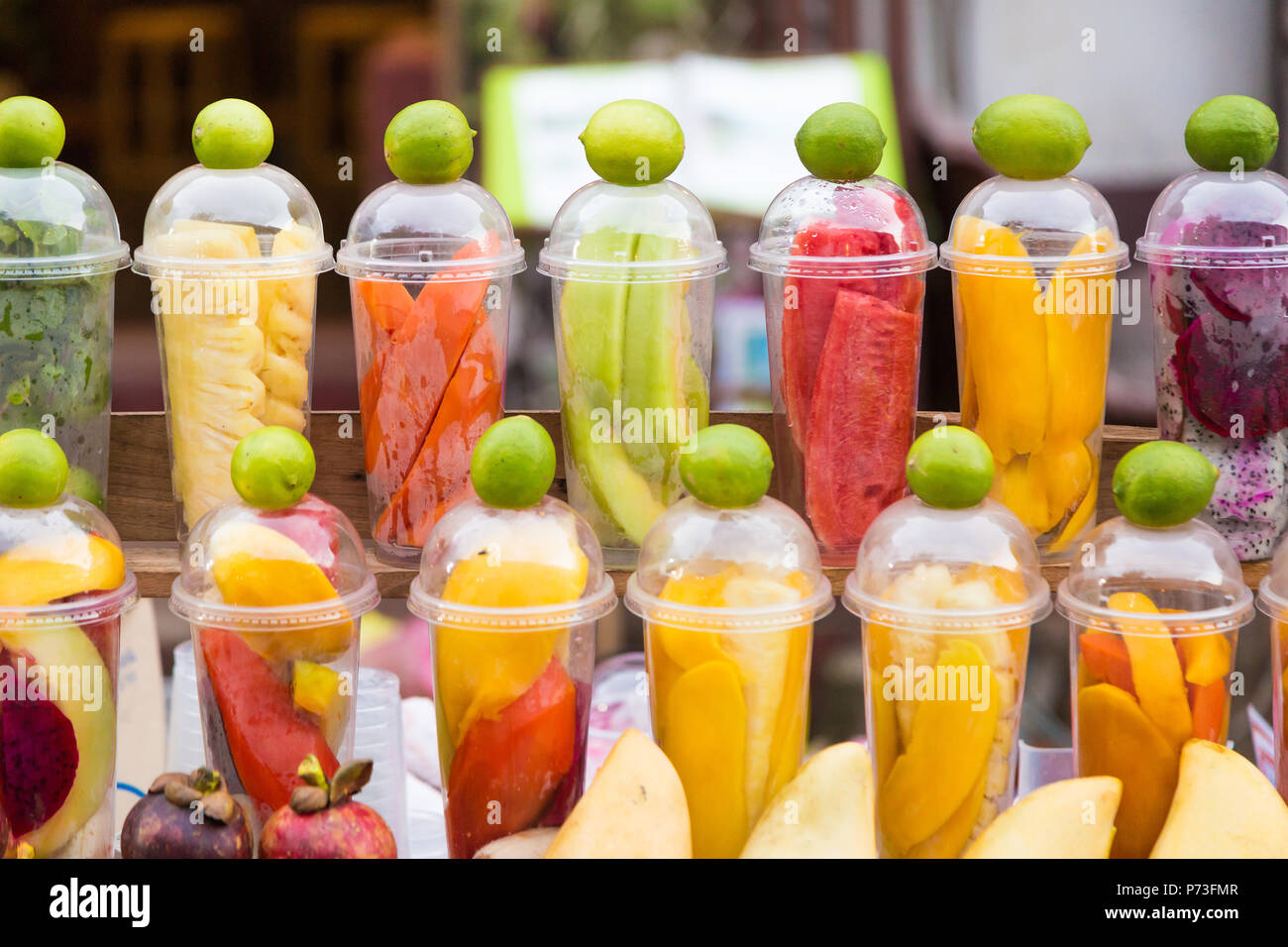 Various tropical fruits prepared in cups for making mixed fruit