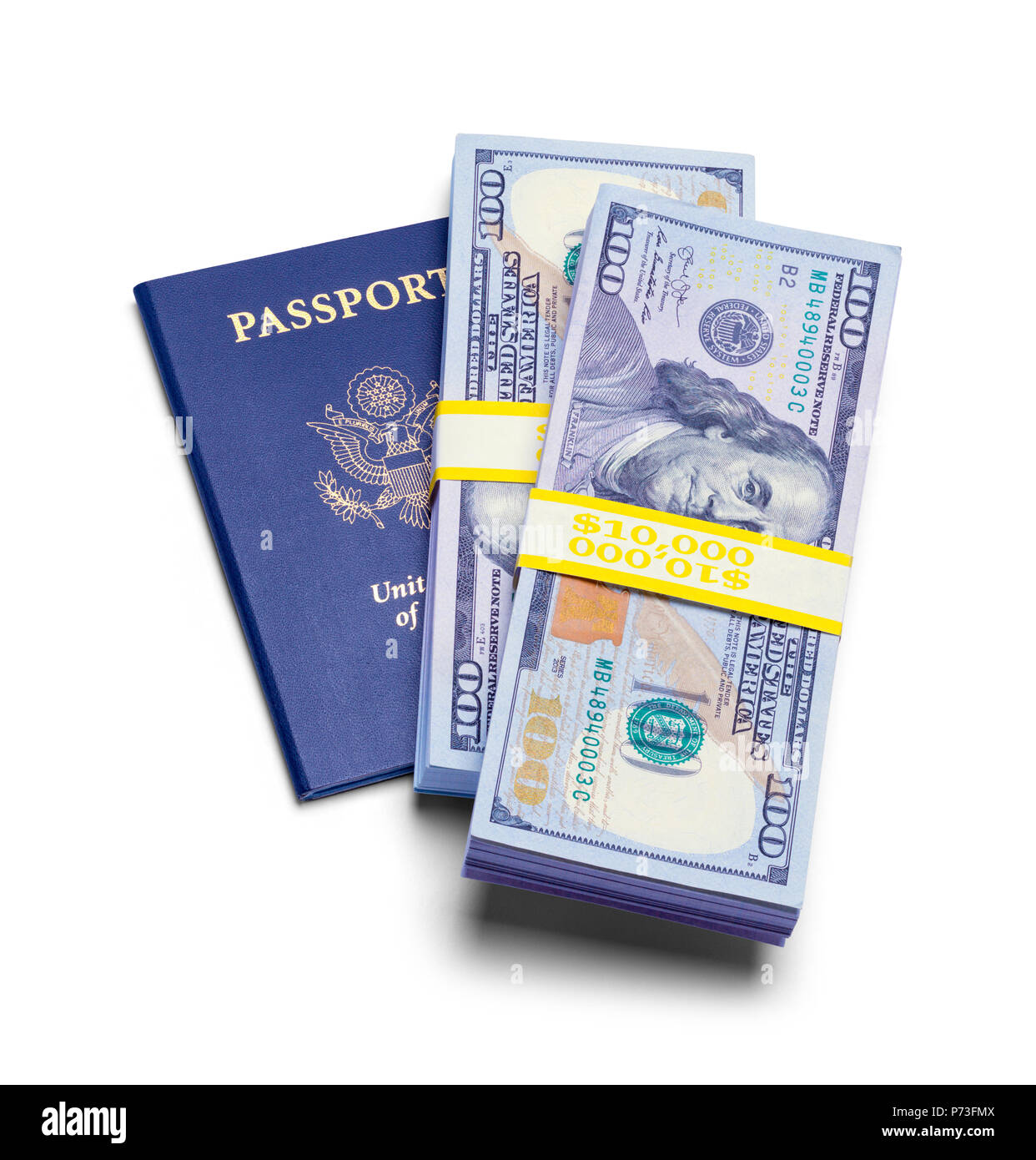 USA Passport with Stacks of Cash Isolated on a White Background. Stock Photo