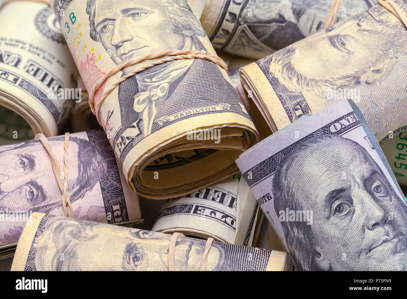 Large Pile Of Various Cash Money Rolls. Stock Photo