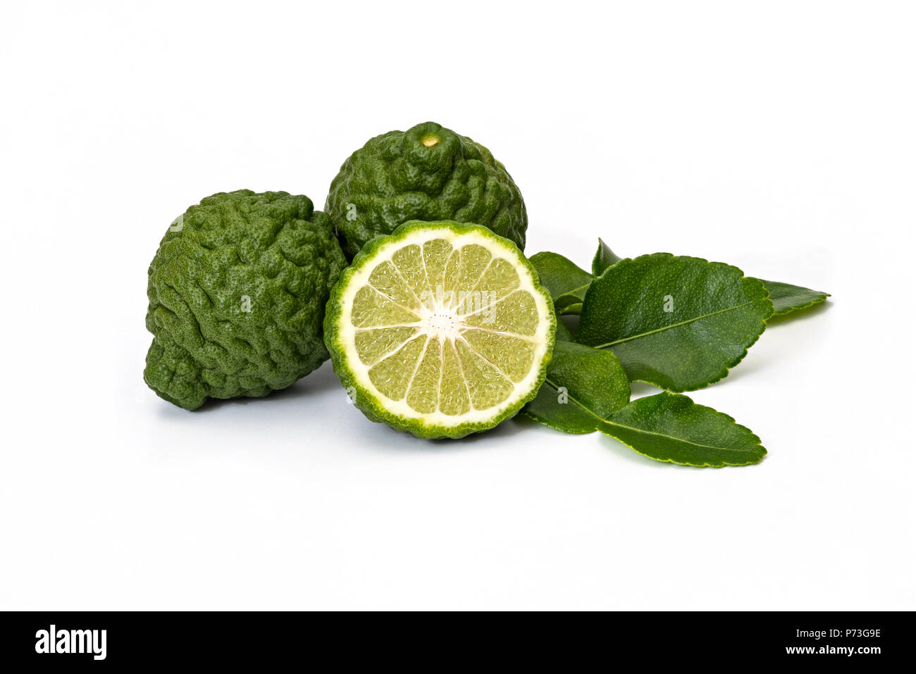 Bergamot fruit kaffir limes and green leaves for herbal products on a white background Stock Photo