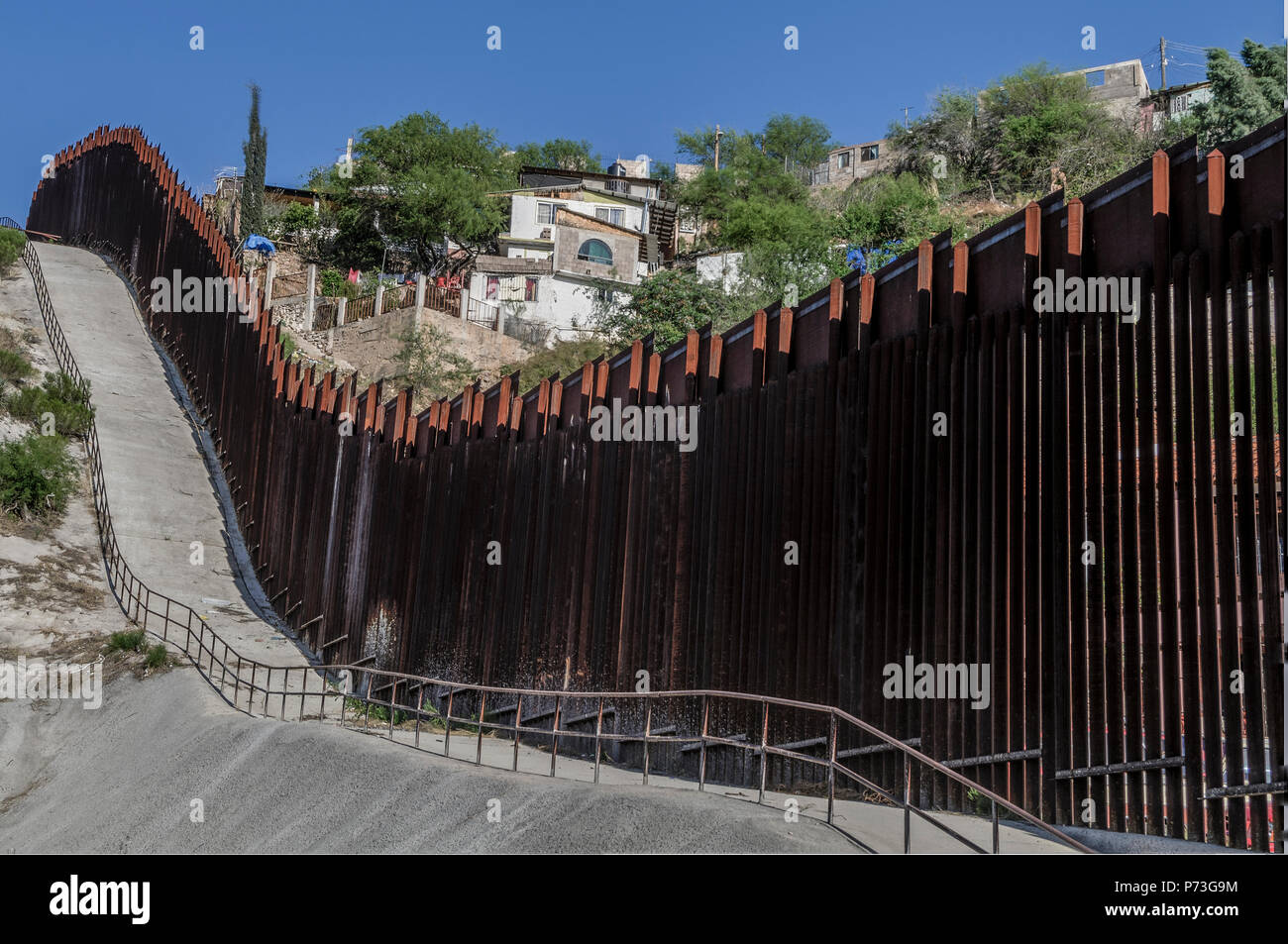 United States Border Fence, viewed from US side showing Nogales Mexico., looking east from near port of entry in downtown Nogales AZ, April 12, 2018 Stock Photo