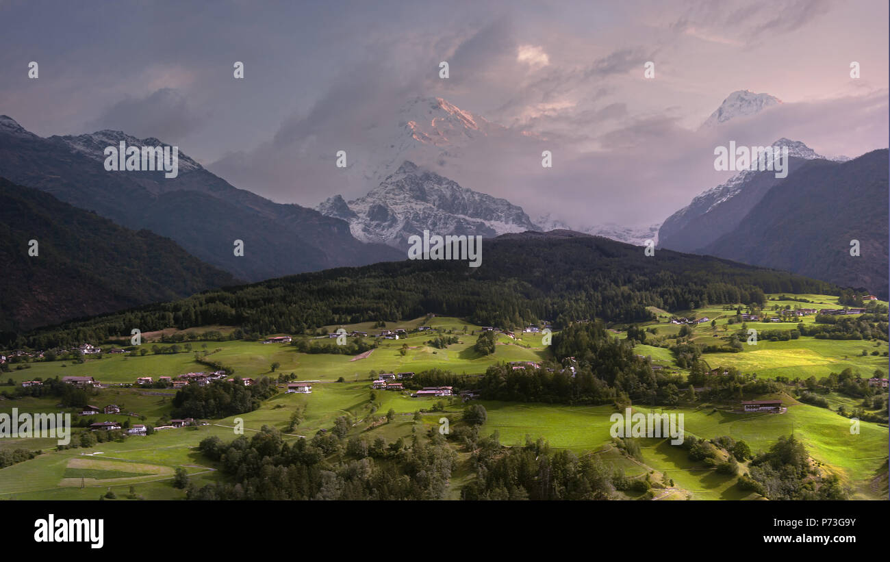Alpine villages in the background of high mountains. Stock Photo