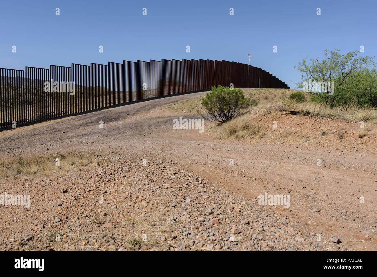 Bollard type border fence approximately one mile west of Nogales (Mariposa) port of entry, Nogales Arizona Stock Photo