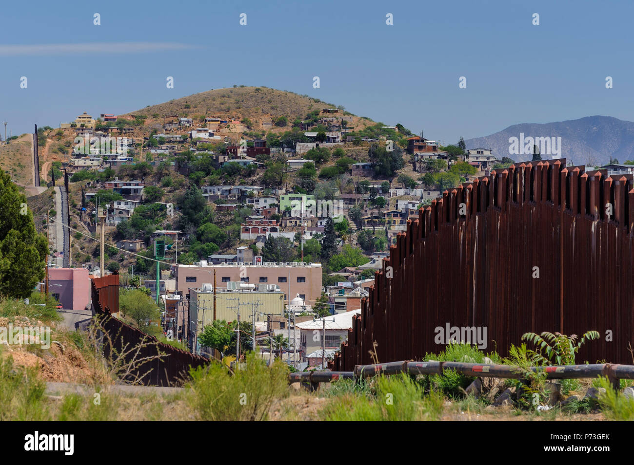 United States Border Fence, pedestrian barrier, looking east from US side, showing Nogales Sonora Mexico on hillside.  April 12, 2018 Stock Photo