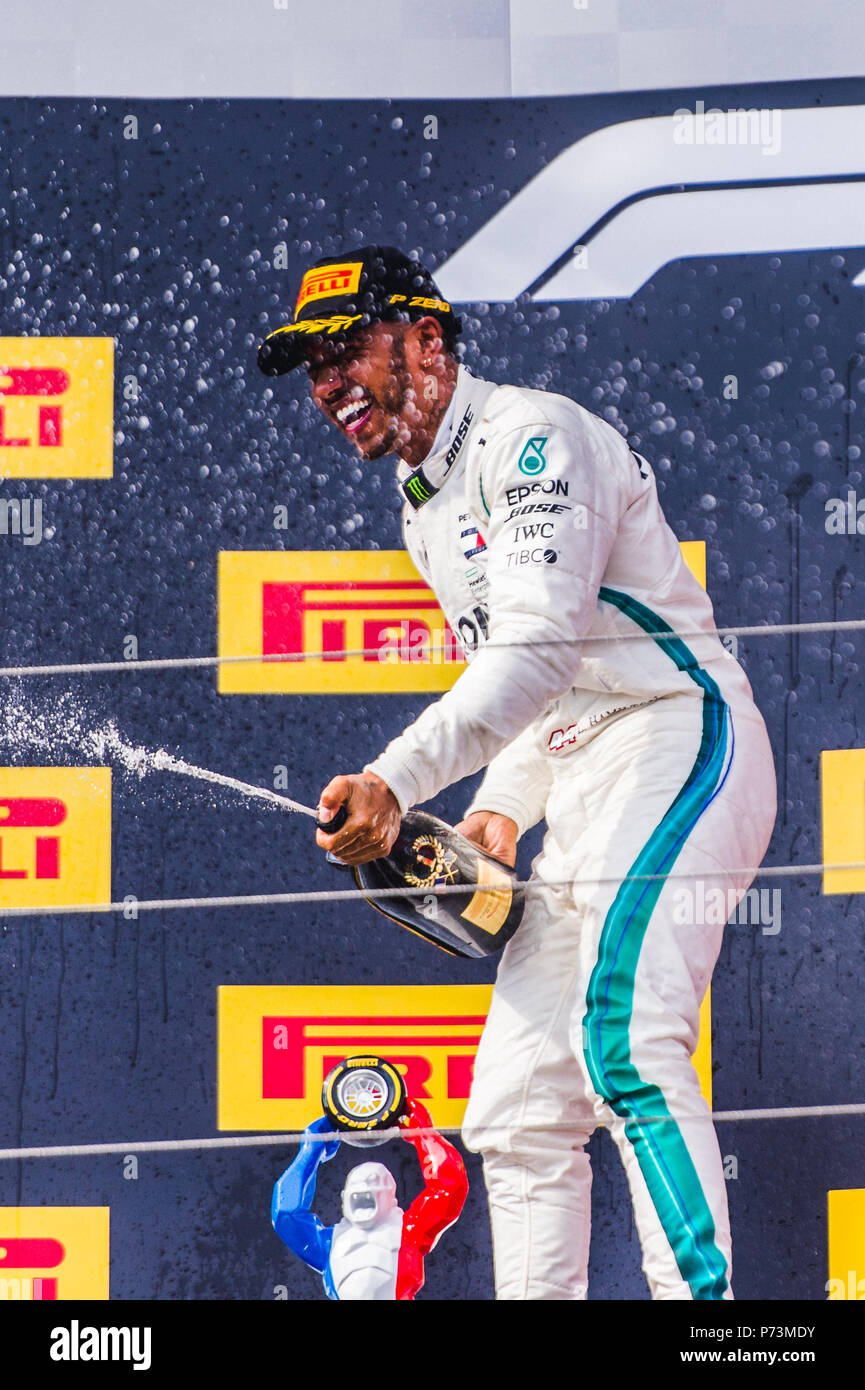 Mercedes racing driver Lewis Hamilton celebrates victory at the 2018 French Grand Prix by spraying champagne on the podium. Credit: Sergey Savrasov / Spacesuit Media. Stock Photo