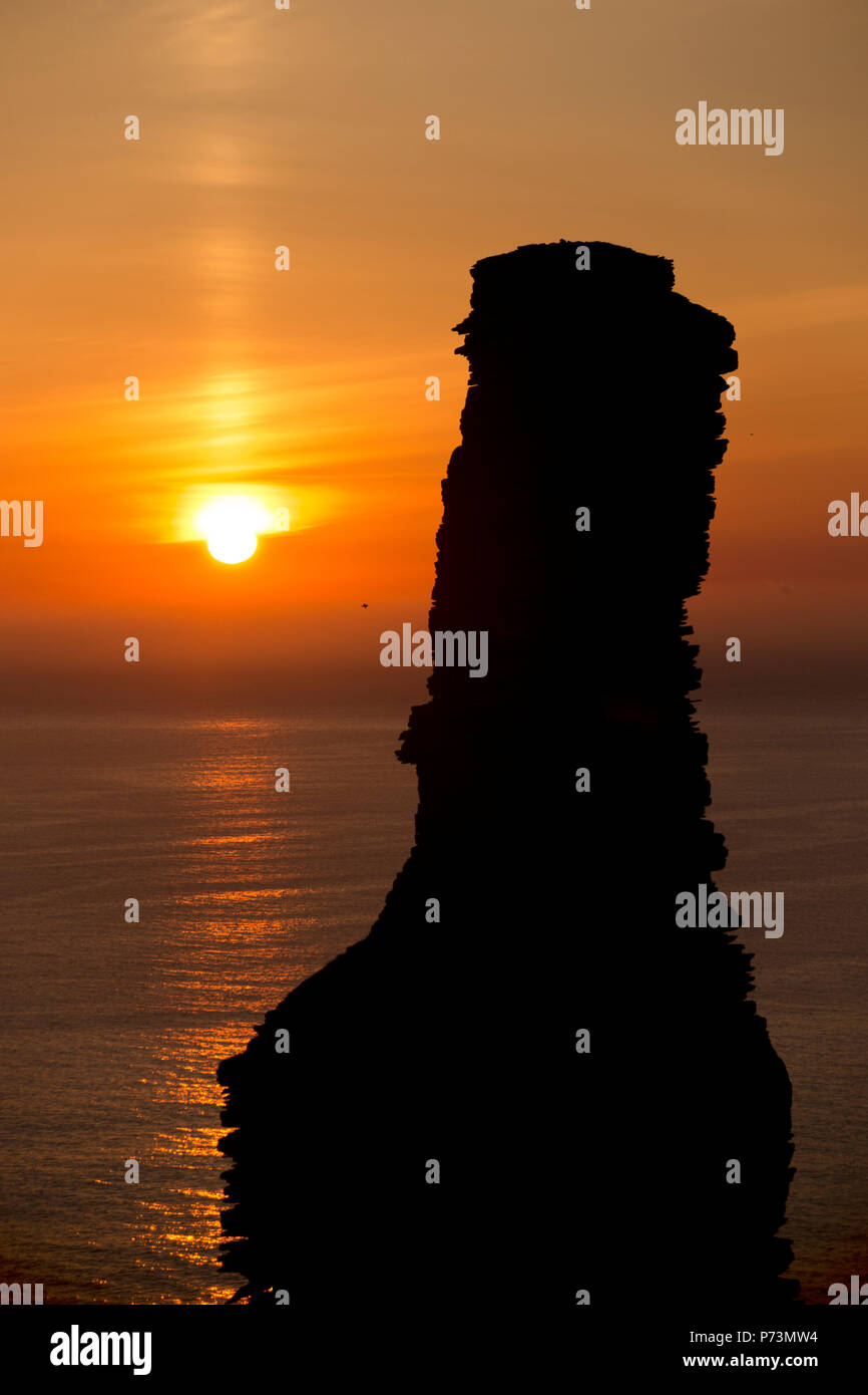 Old Man of Hoy sea stack silhouetted against a setting sun Stock Photo ...