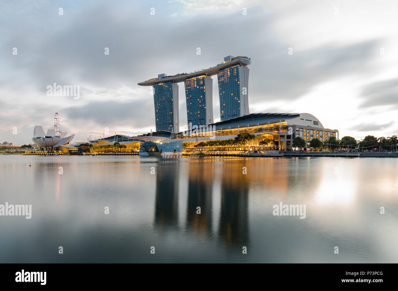 A beautiful dawn at Marina Bay with Marina Bay Sands Hotel at the background, one of the most spectacular Hotel in Singapore. Stock Photo