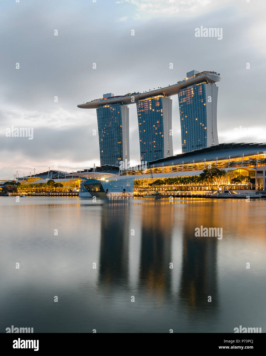 A beautiful dawn at Marina Bay with Marina Bay Sands Hotel at the background, one of the most spectacular Hotel in Singapore. Stock Photo