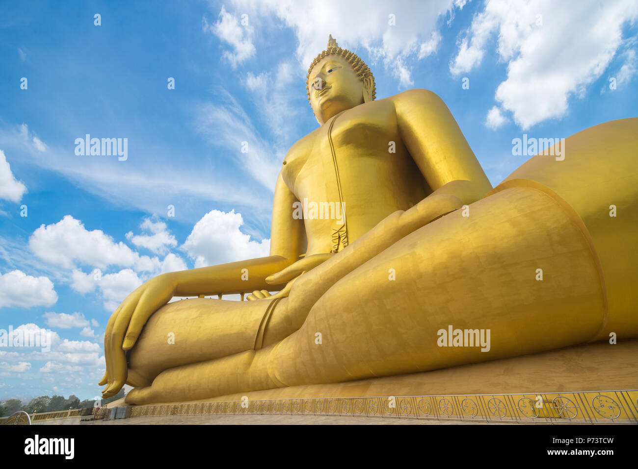 buddha image. Big golden buddha statue sitting on blue sky background Stock Photo