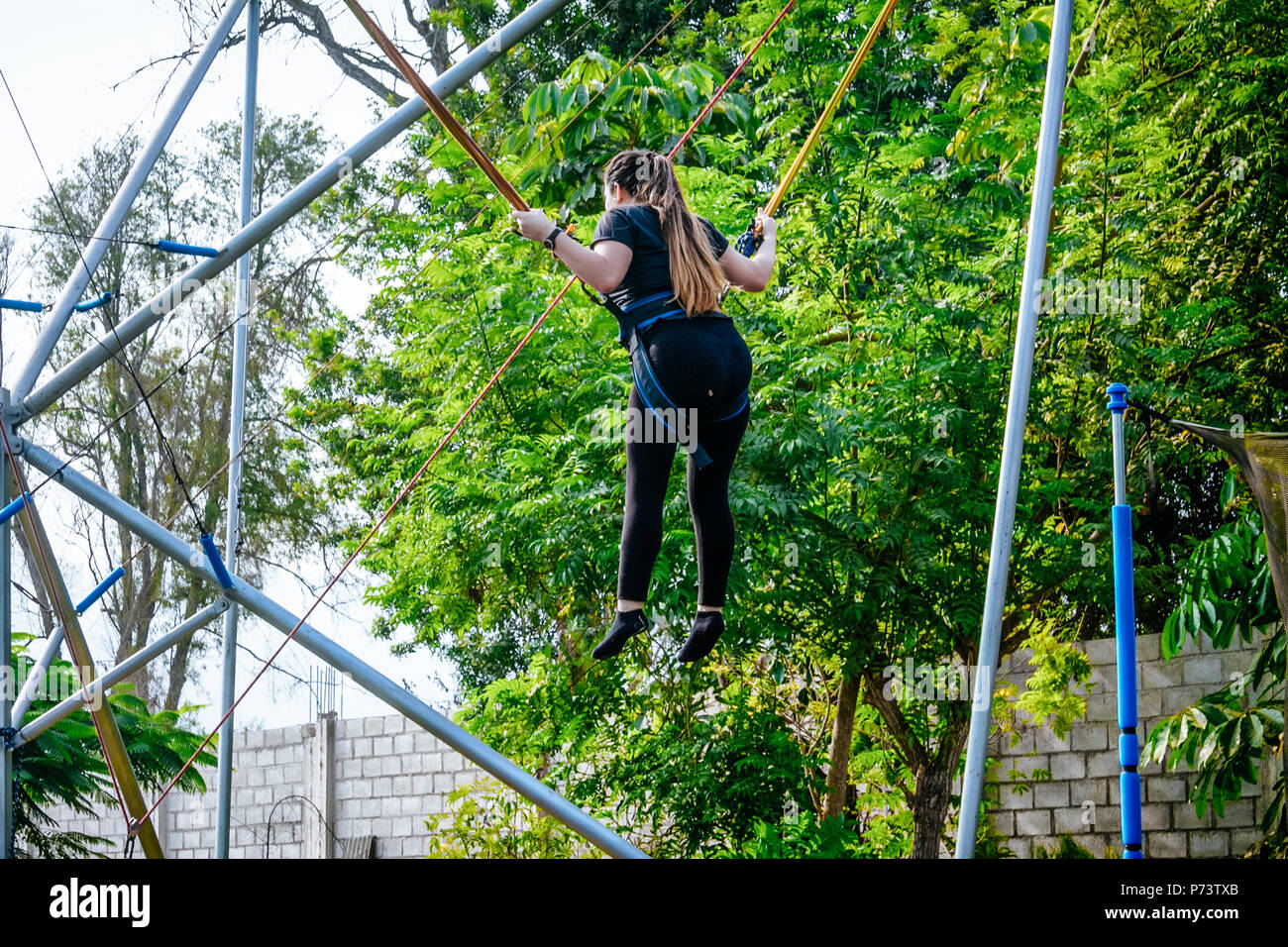 Young girl having fun on the rope jumping in the morning Stock Photo