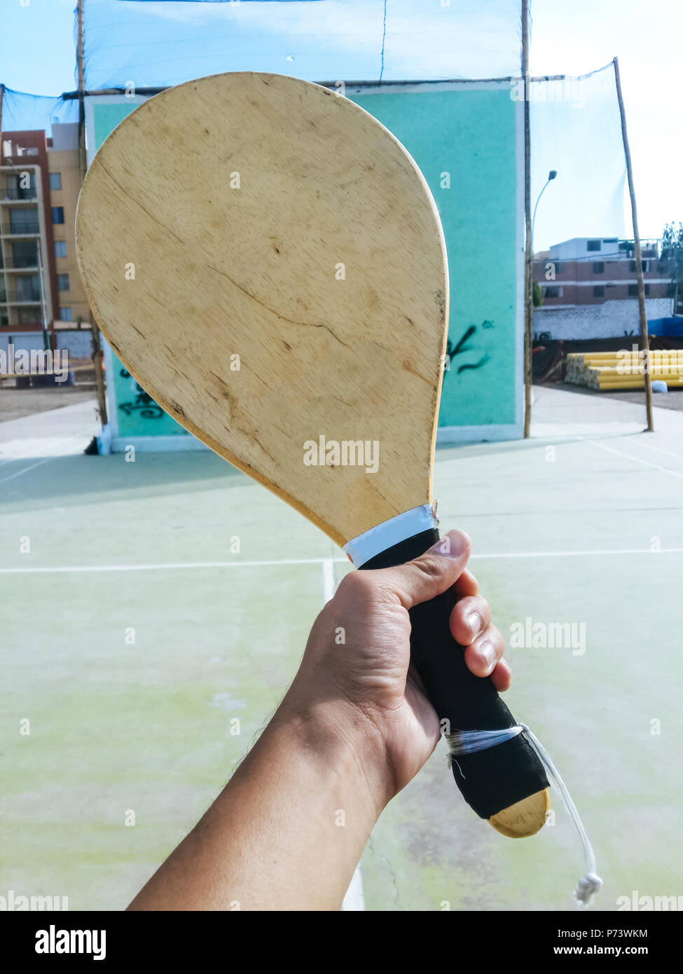 Wooden racquet for Fronton game, one-handed racquet with bottom of the wall to play fronton Stock Photo