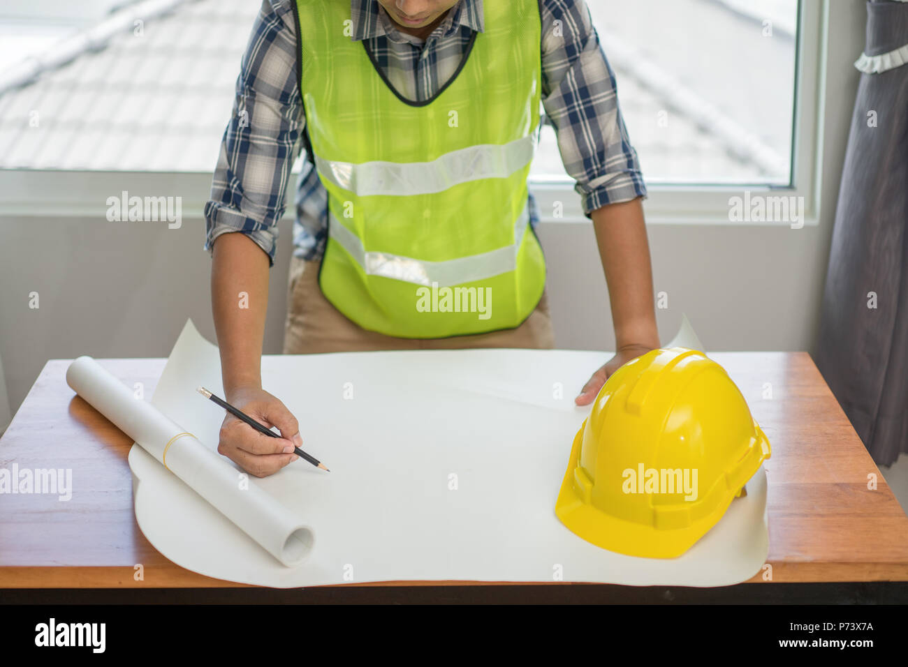 Architect working on blueprint. Architects workplace, Architectural project, Construction concept, Engineering tools Stock Photo