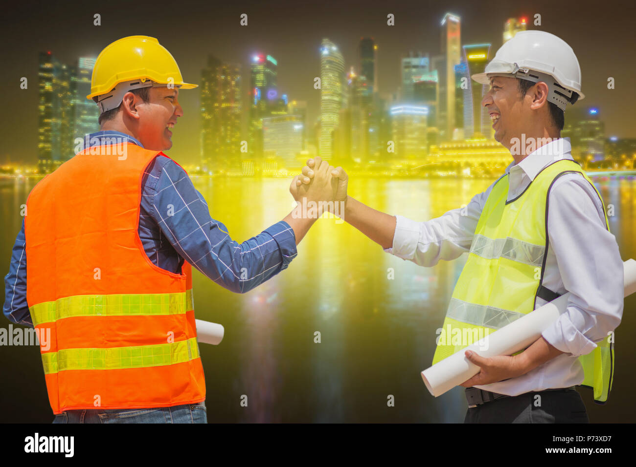 Handsome construction workers in protective helmets and vests are