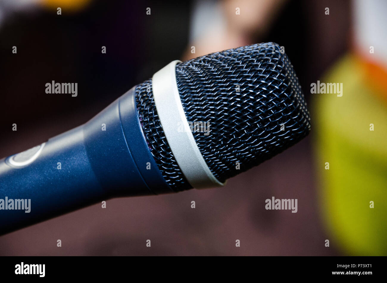 Microphone on abstract blurred of speech in seminar room or speaking conference hall light, Event Background Stock Photo