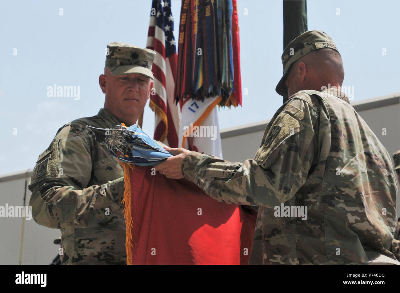 Lt. Col Bruce Bredlow and Command Sgt. Maj. Neil Sartain, command team of the 2nd Battalion, 43rd Air Defense Artillery Regiment, uncase the battalion’s colors as they assume command authority May 12, 2017 in Southwest Asia. The 2-43 ADA follows 1-43 ADA, which will be returning to El Paso, TX.  ( Stock Photo