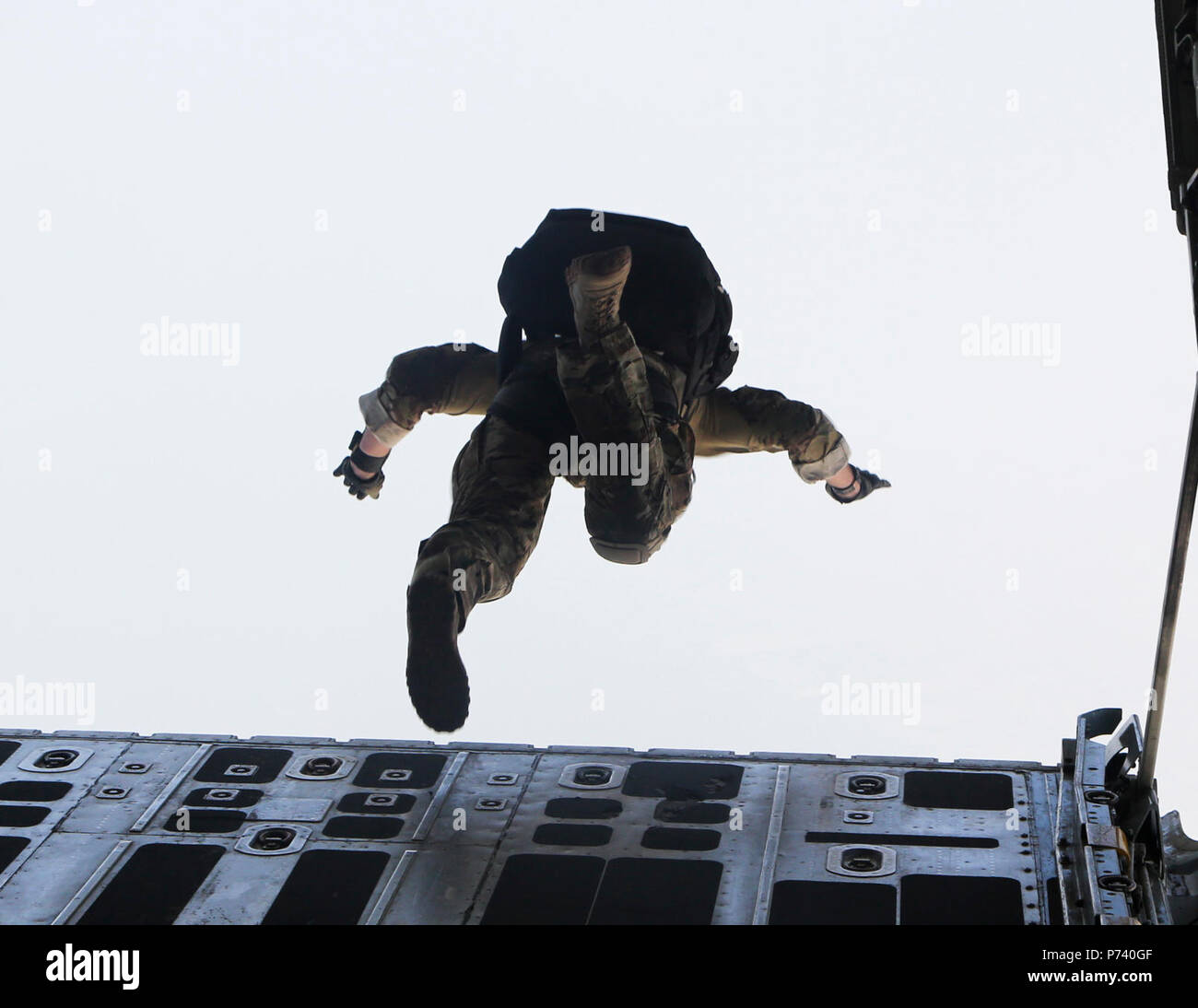 A U.S. Special Operations Force member exits a U.S. Marine Corps KC130-J attached to Marine Aerial Refueler Transport Squadron 352, Special Purpose Marine Air-Ground Task Force-Crisis Response-Central Command, during free fall parachute training over Bahrain, May 11, 2017. Deploying U.S. Marines into the USCENTCOM area of operation to conduct combined military training with our partner nations’ security forces strengthens our vital relationships with partners in this important region. Stock Photo