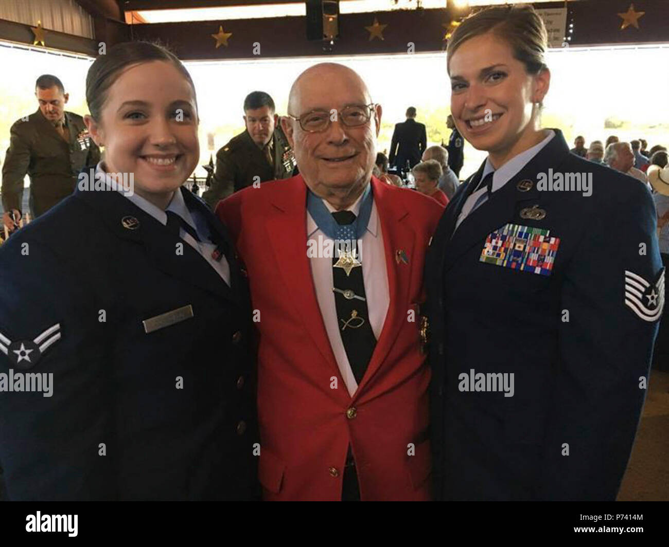 U.S. Air Force Airman 1st Class Emily Copeland (left) and Tech. Sgt. Rashelle Gomez (right) take a photo with Hershel 'Woody' Williams, the last living Medal of Honor recipient from the Battle of Iwo Jima at Fort Chadbourne, Texas, May 11, 2017. Williams spoke on his advocacy for Gold Star Families and pinned Vietnam veterans during his Dinner with a Hero event. Stock Photo