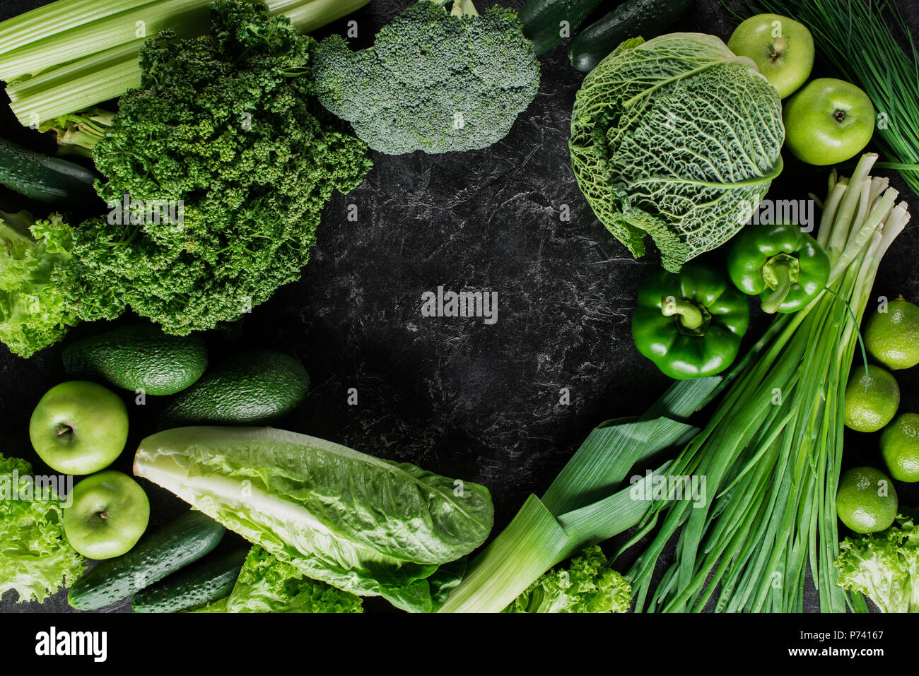 top view of green vegetables on dark concrete table, healthy eating ...